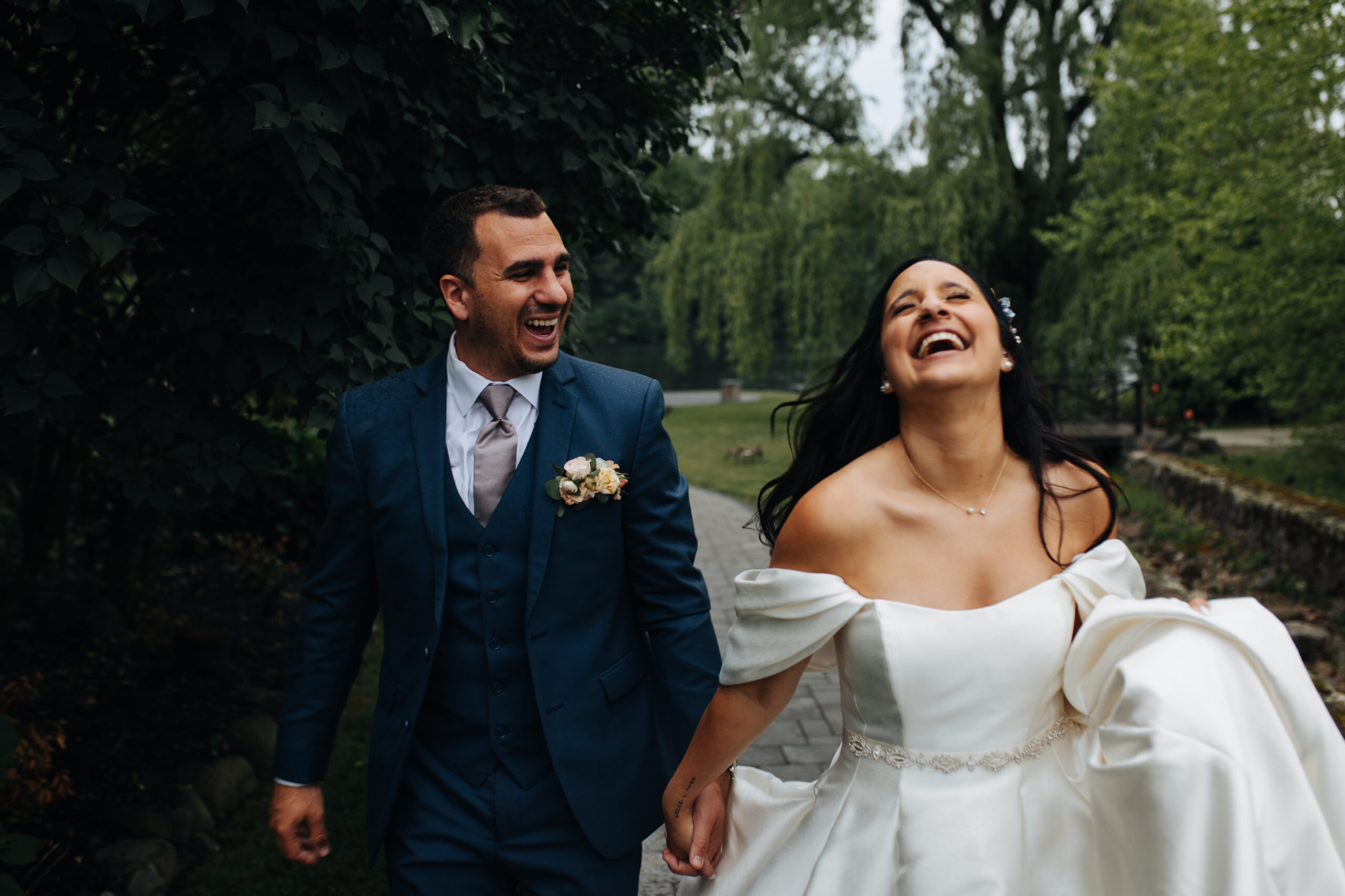 Bride and groom smiling as a wedding videographer photographer team takes footage of their wedding day in Hudson Valley