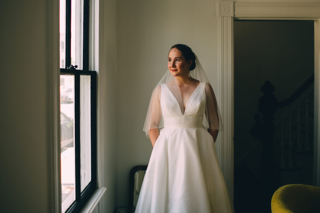 Bride is ready in her wedding dress with her hair and makeup complete on a snowy wedding day