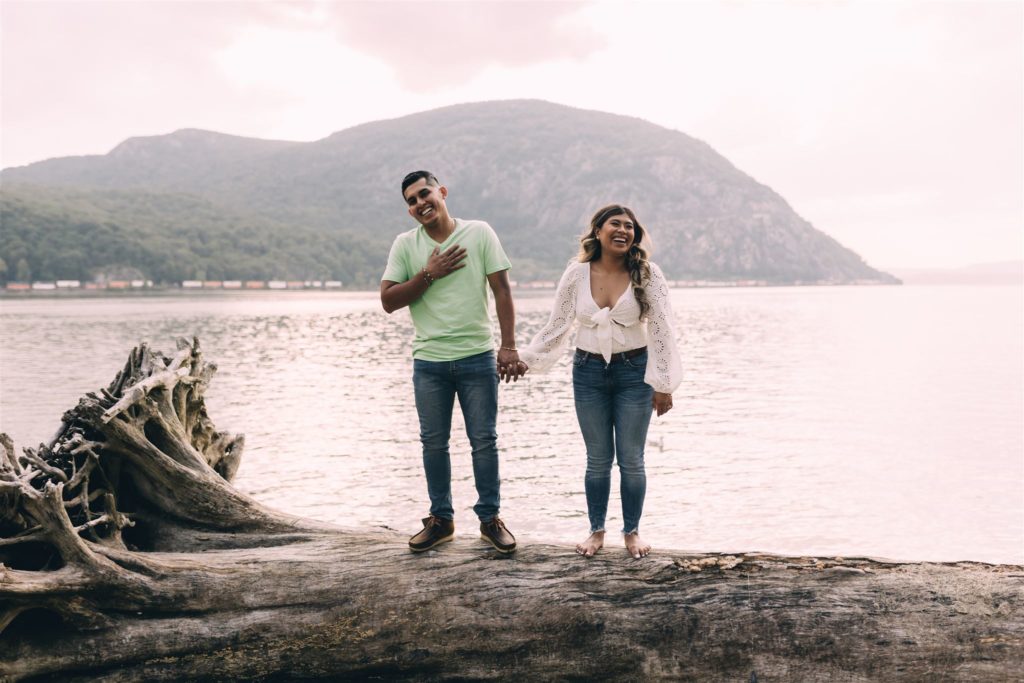 engagement photo poses - holding hands while standing apart from each other